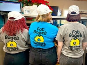 Fat Bagels' employees model our "Schmeer the Hole" tee shirts.